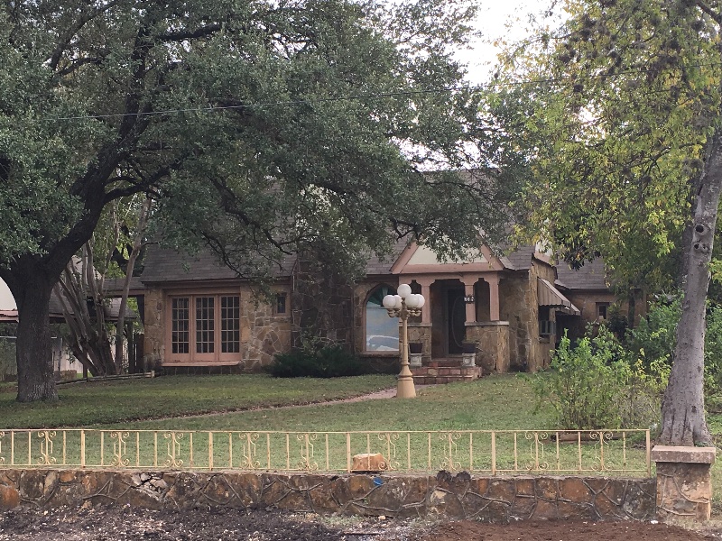 House behind tall tree in Greenlawn